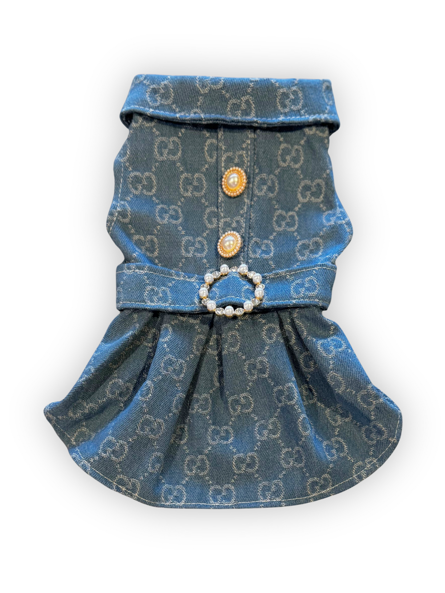 Small dog wearing structured denim dress with pearl button accents, collar, and rhinestone belt buckle