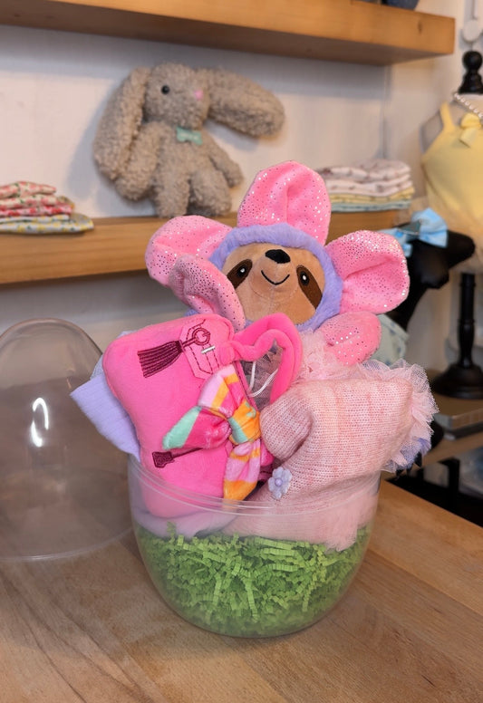 Girly dog Easter basket with pink outfit and plush toy styled inside clear egg from The Pawster