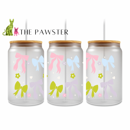 UV DTF cup wrap with pastel bows in pink, blue, lilac, and green with small white hearts and flowers on a clear background