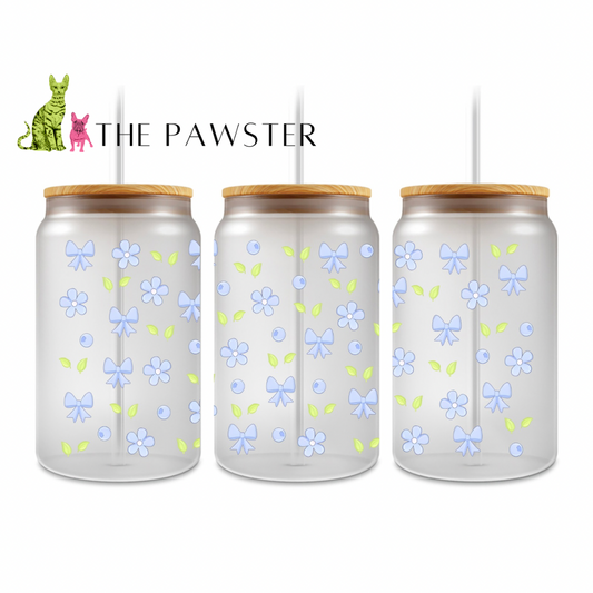 Double-sided UV DTF wrap with light blue bows, small blue berries, and green leaves on a clear glass can
