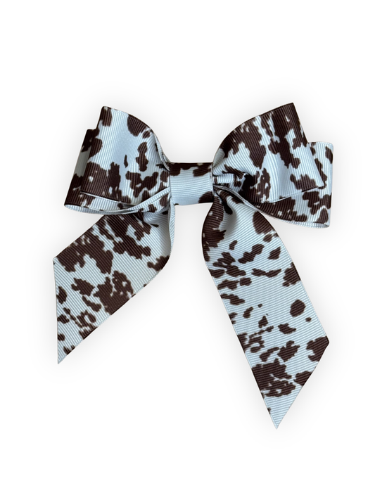 Handmade cow print dog hair bow with alligator clip from The Pawster Rodeo Luxe collection