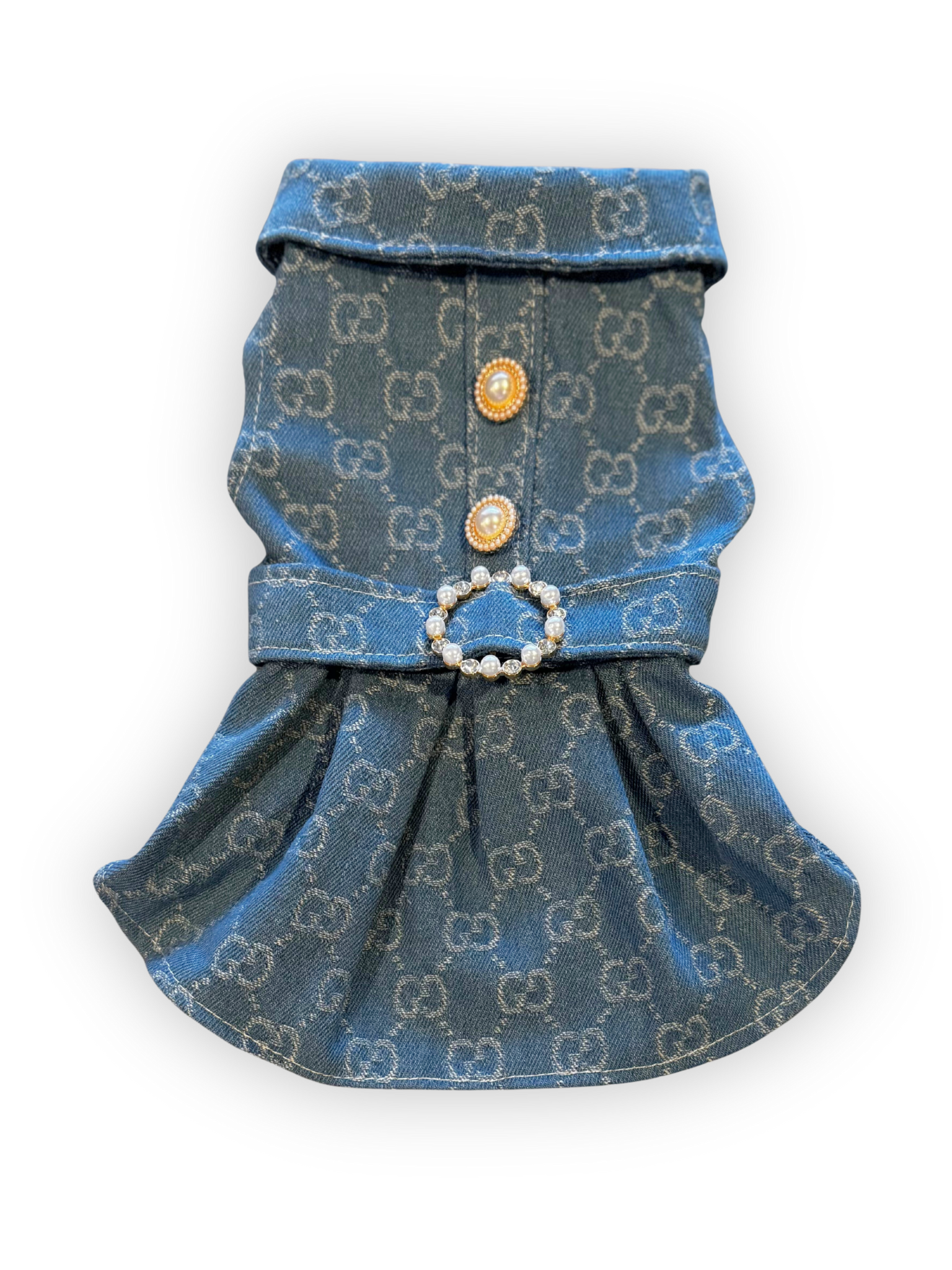 Small dog wearing structured denim dress with pearl button accents, collar, and rhinestone belt buckle