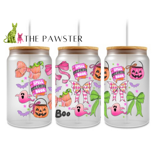 Neon Halloween UV DTF cup wrap with bright pink ghosts, green bows, pumpkins, bats, and spell books on a clear glass can.