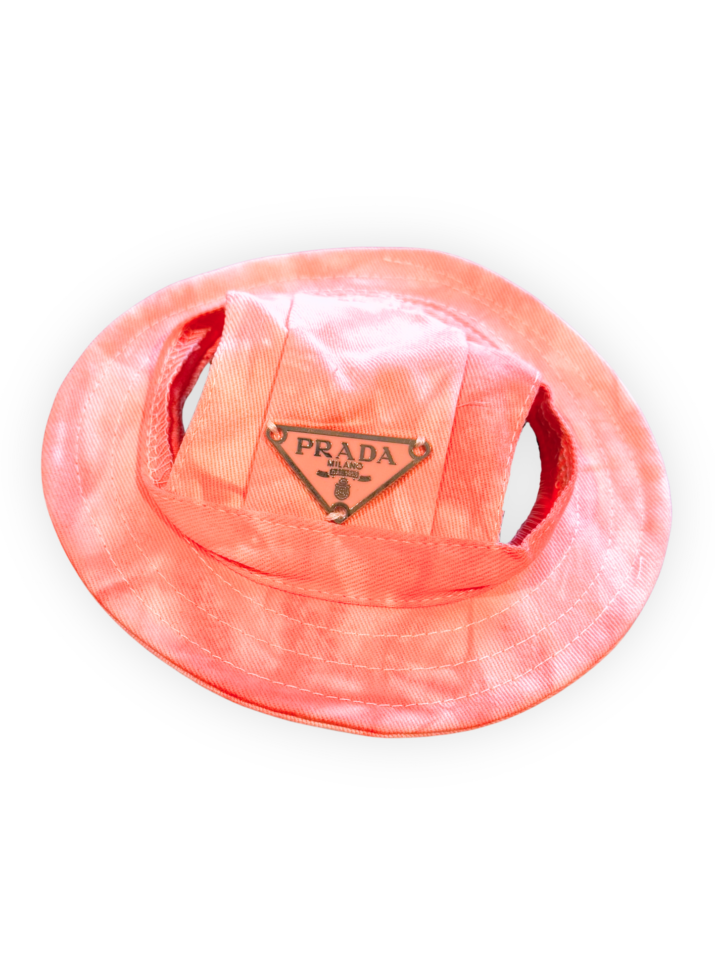 Small dog wearing lightweight bucket hat with ear openings and adjustable chin strap