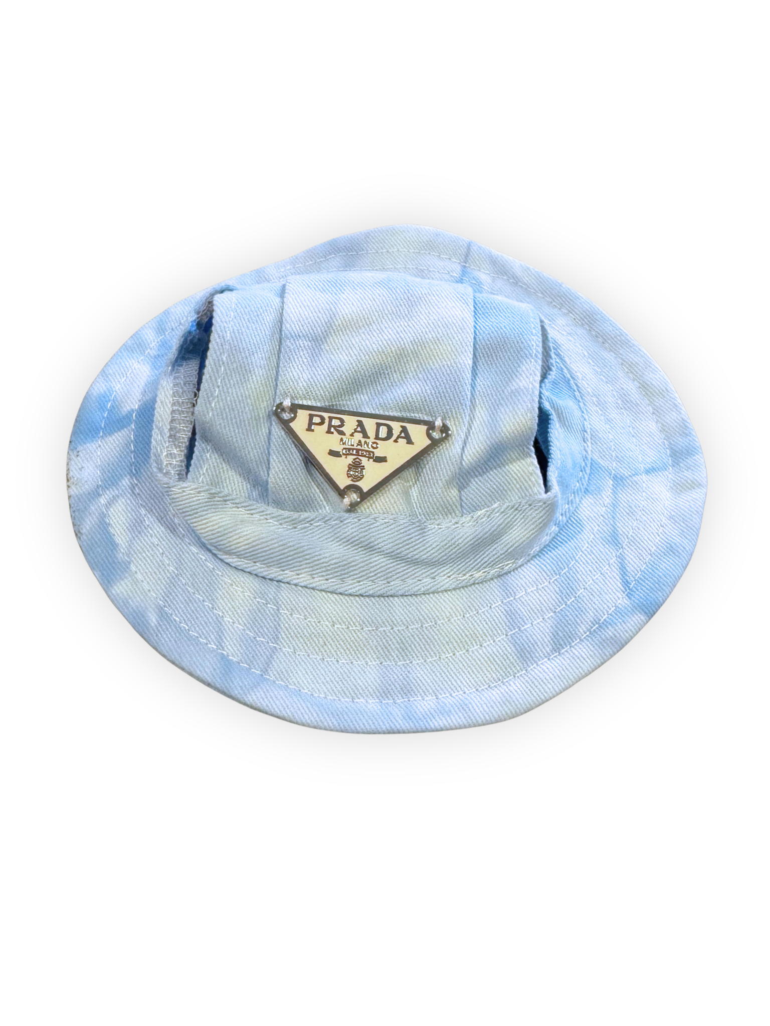 Small dog wearing lightweight bucket hat with ear openings and adjustable chin strap