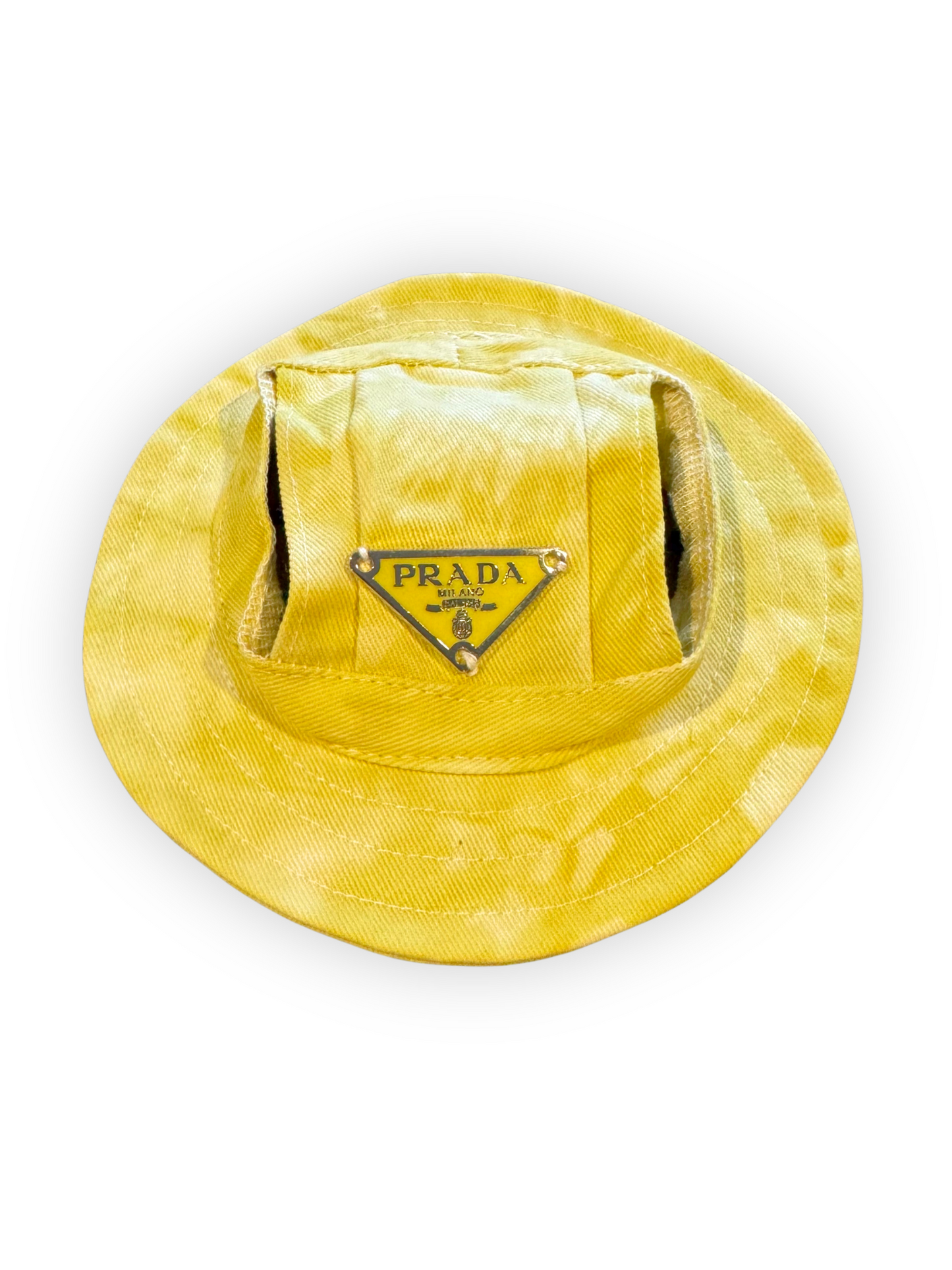 Small dog wearing lightweight bucket hat with ear openings and adjustable chin strap