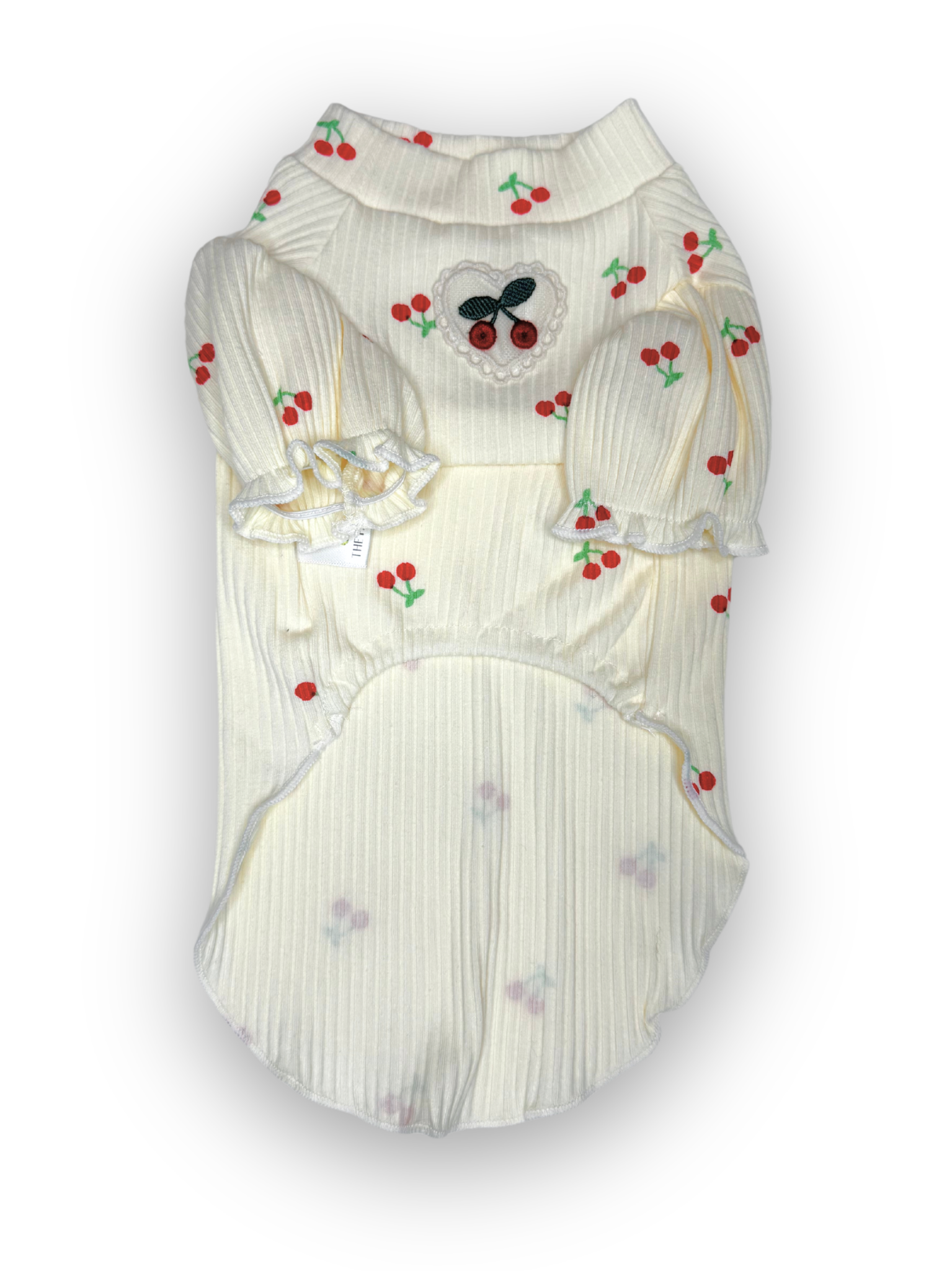 A white ribbed pet top with cherry design and puff sleeves, featuring a lace heart with cherries detail on the chest.