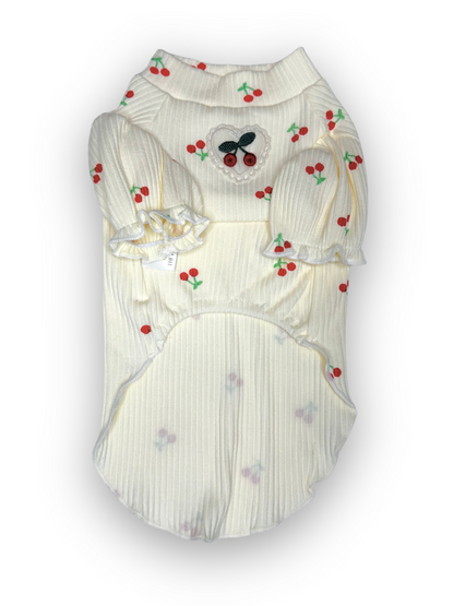 A white ribbed pet top with cherry design and puff sleeves, featuring a lace heart with cherries detail on the chest.